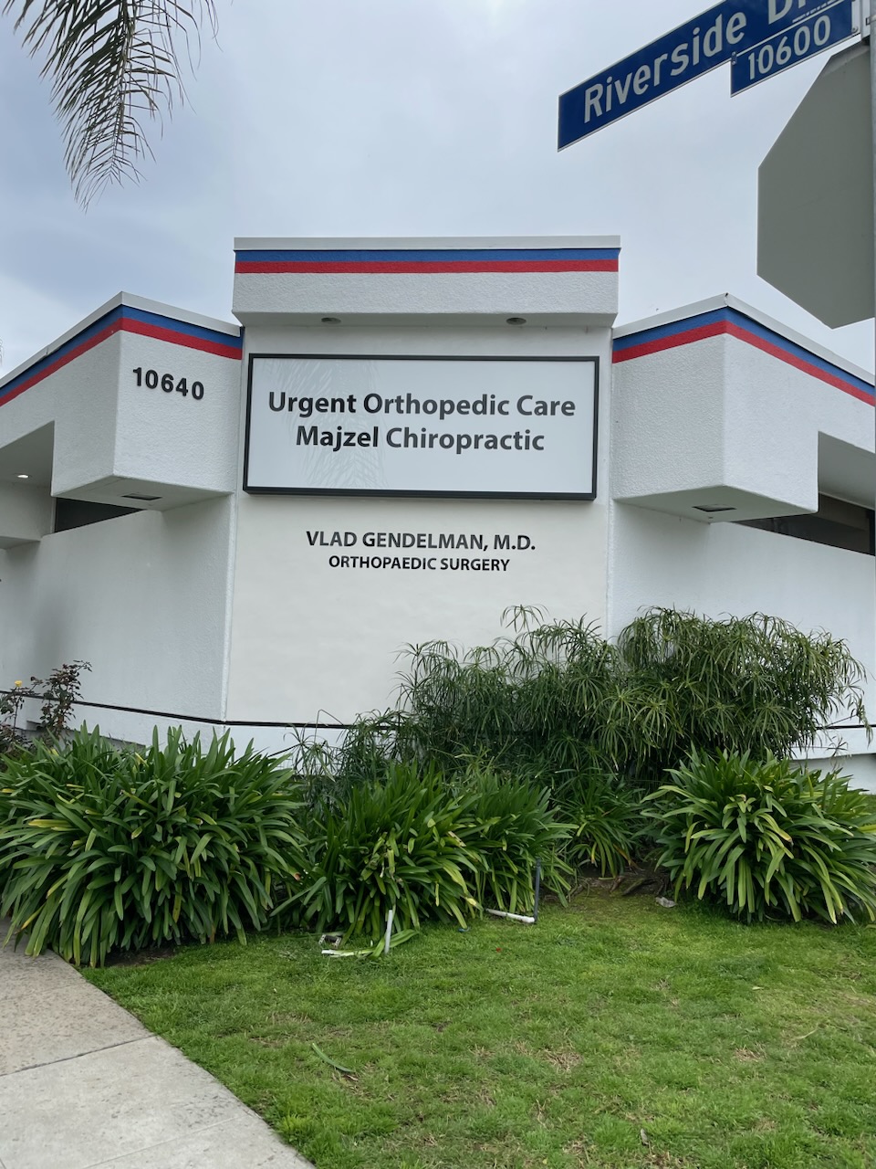 Exterior medical-office sign reading Urgent Orthopedic Care and Majzel Chiropractic with physician lettering below